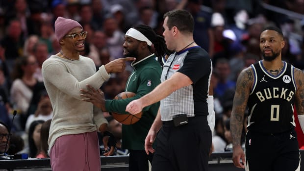 Los Angeles Clippers guard Russell Westbrook (left) talks with Milwaukee Bucks guard Patrick Beverley (21) 